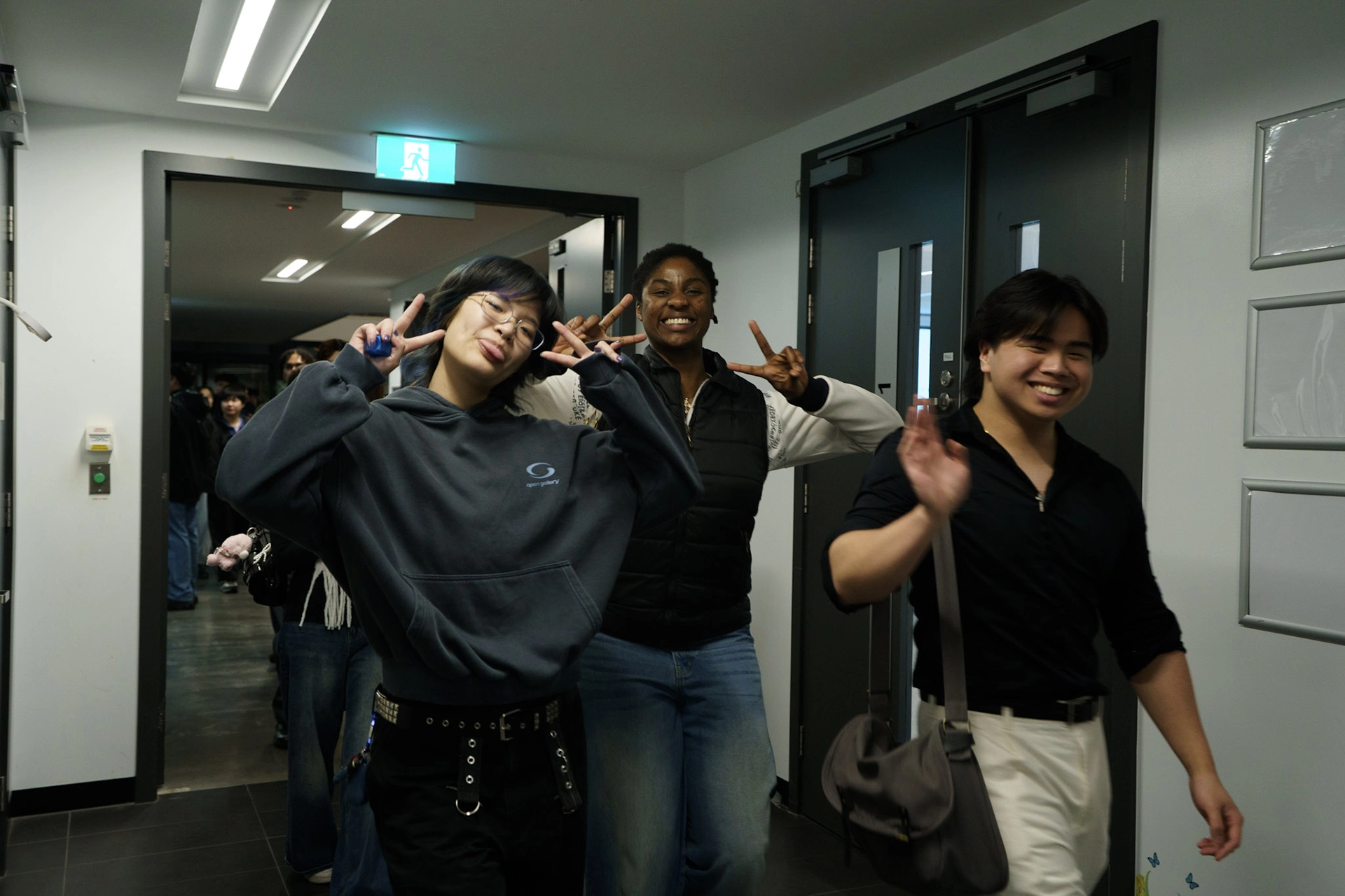 Young adults smiling and waving as they arrive at church